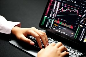Person trading Dax strategies on laptop